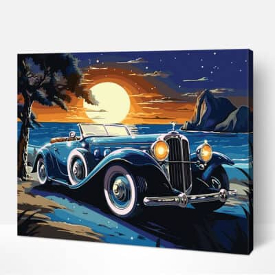 A vintage car is parked on a beach at night, with the sun setting in the background.